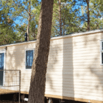 Sunlit Cream Mobile Home Among Pines